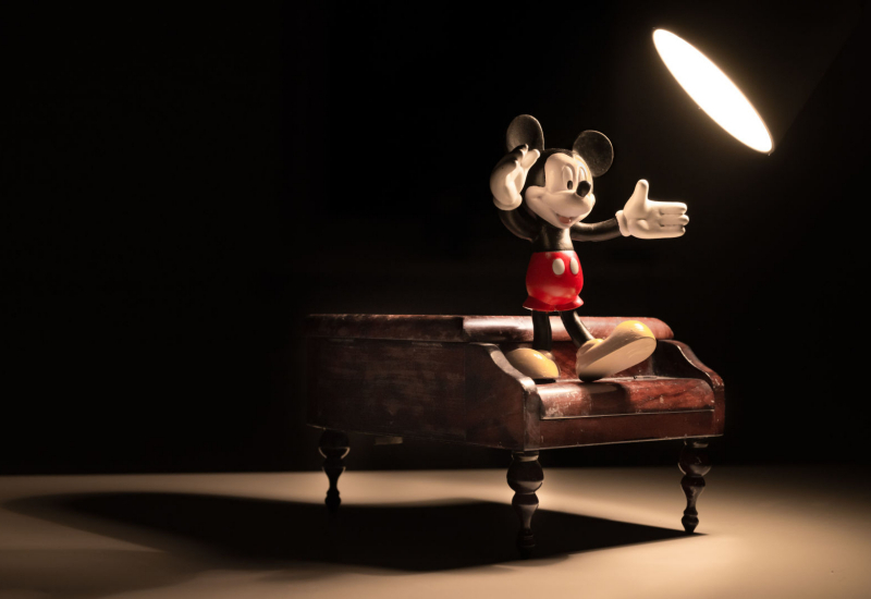 Ilustrasi sejarah kejayaan Walt Disney dan watak Mickey Mouse.