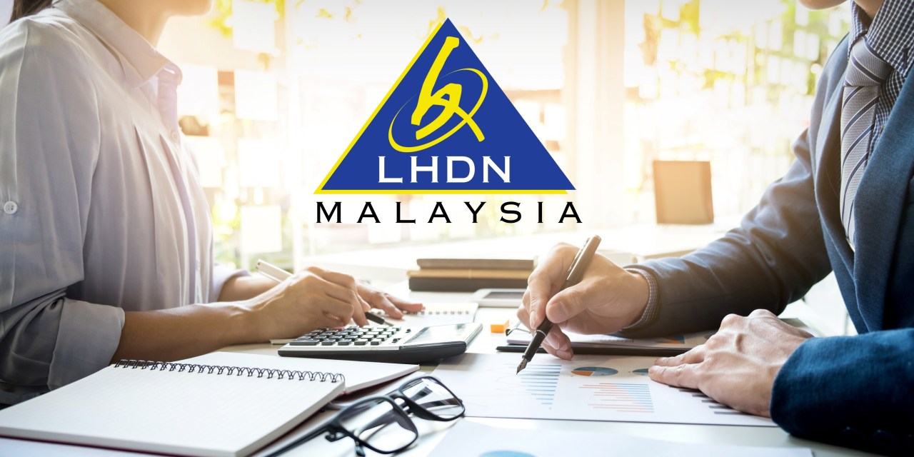 Lelaki bekerja di pejabat dengan komputer riba dan dokumen di atas meja merujuk kepada konsep duti setem.