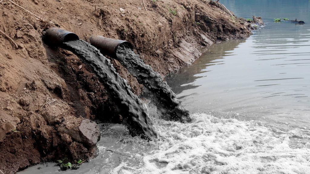 Sungai dipenuhi sampah dan air keruh akibat pencemaran air oleh manusia.